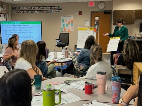 Dr. Kara Imm talking with teachers at a Buffalo Math Collaborative Meeting